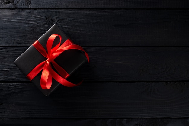 Boxing day concept. Top view of black christmas boxes on black wooden table. Copy space