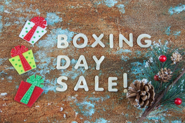 Boxing day sale and felt gift boxes on shabby background.