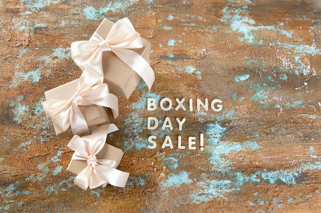 Boxing day sale and gift boxes on shabby background. Copy space for text