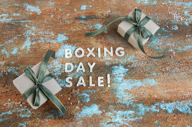 Boxing day sale and gift boxes on shabby background. Copy space for text