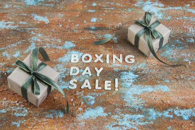 Boxing day sale and gift boxes on shabby background. Copy space for text