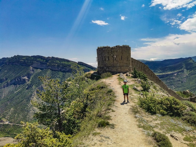 A boy against the background of the Gunib fortress A protective wall Russia Dagestan June 2021