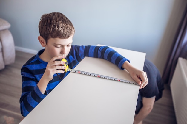 Boy assembling furniture