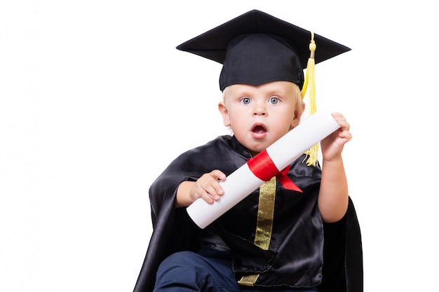 A boy in a bachelor or master suit with diploma scroll isolated