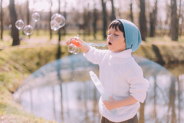 The boy blows soap bubbles lifestyle Children's entertainment Children's portrait