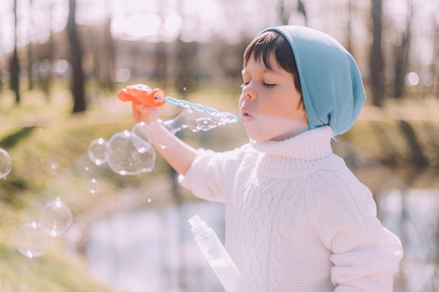 The boy blows soap bubbles lifestyle Children's entertainment Children's portrait