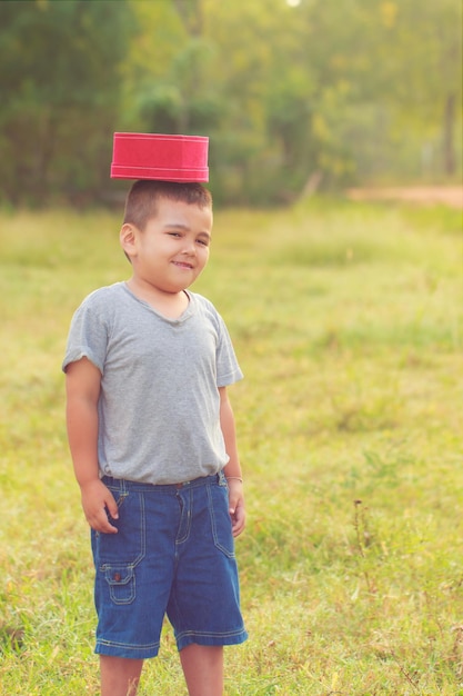 The boy cheerful on morning time park and outdoorAsian boy