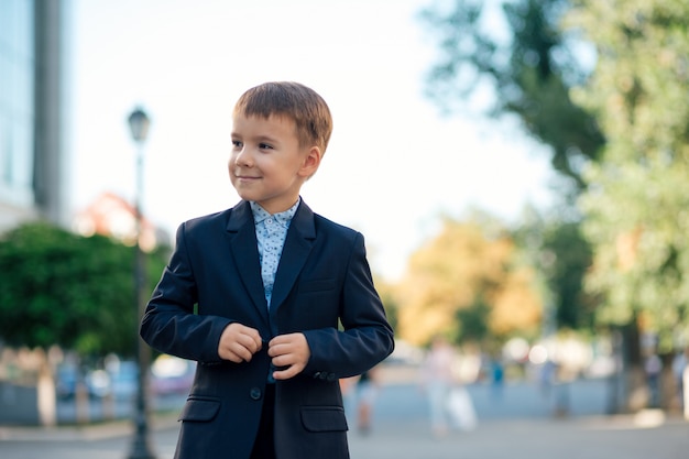 Boy in classic modern dark blue business costume