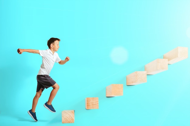 Boy climbing wooden blocks