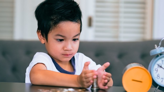 Boy collecting money or counting his savings