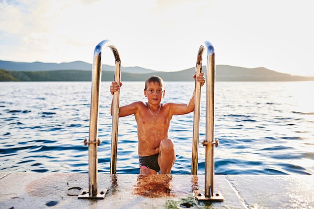 The boy comes out of the sea after bathing. High quality photo