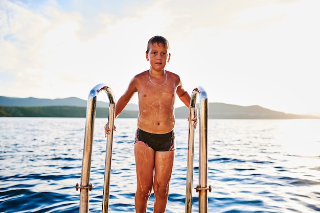 The boy comes out of the sea after bathing. High quality photo