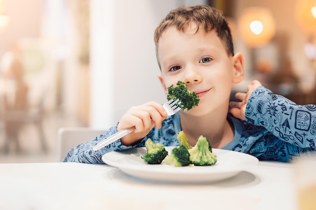 boy eating broccoli healthy food