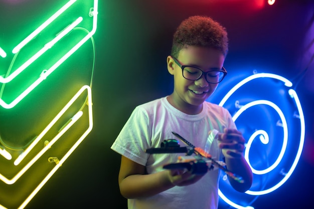 Boy engrossed in a game with a toy helicopter