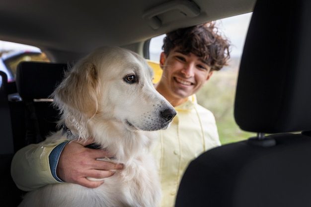 Boy enjoying a familiar road trip with his dog