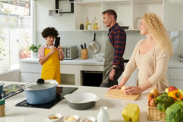 Boy Filming Family Cooking Dinner