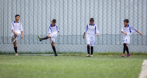 Boy Football Player training session running exercise for Children