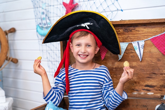 Boy in the form of pirates at the helm. holiday decoration pirate style