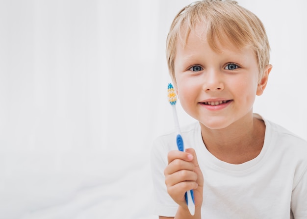 Boy getting ready to brush his teeth with copy space