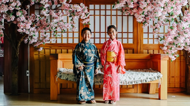 The boy and girl are happily dressed in a kimono.