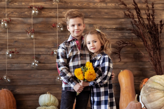 Boy and girl are standing in autumn