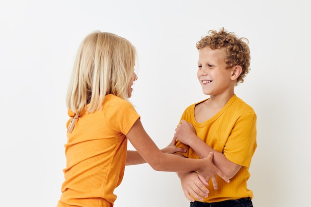 Boy and girl casual wear games fun together posing emotions quarrel isolated background unaltered