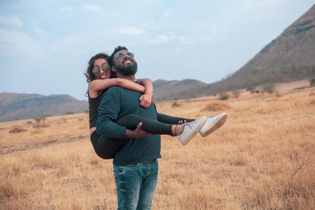 Boy and girl piggy back riding.