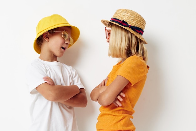 Boy and girl wearing hats fashion glasses posing friendship fun