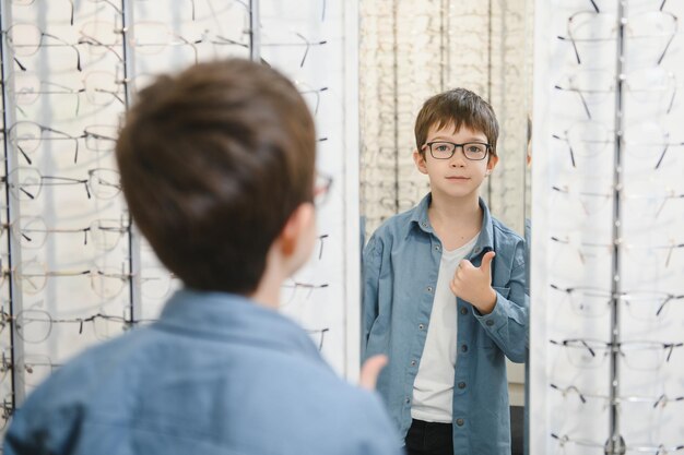 Boy in glasses at optics store