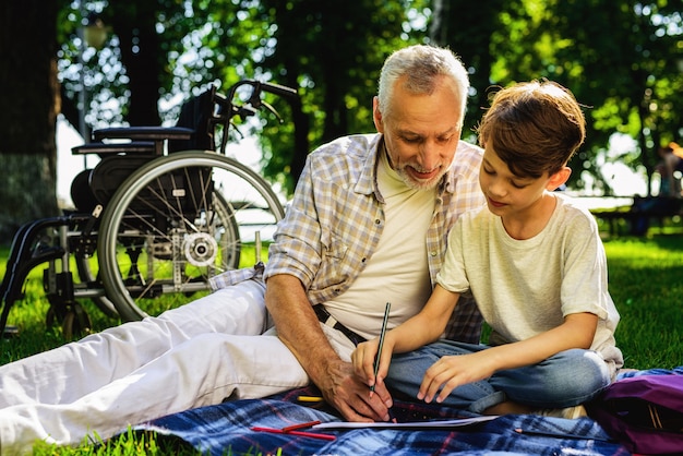 Boy and Grandfather Draw Notbook Family Picnic