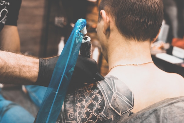 Boy having a tattoo done