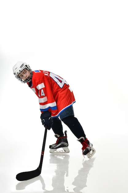 Boy hockey player in studio silhouette isolated on white background