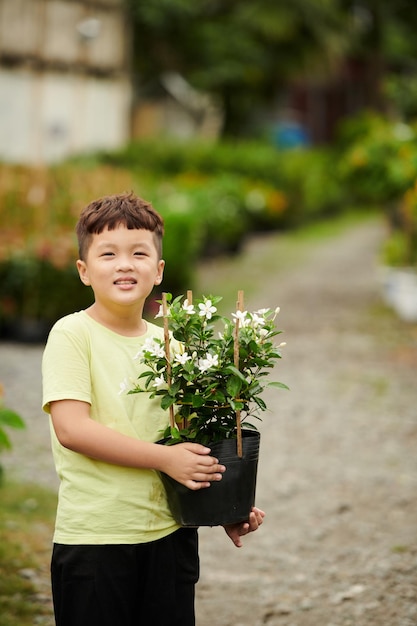 Boy Holding Pot with Blooming Flower