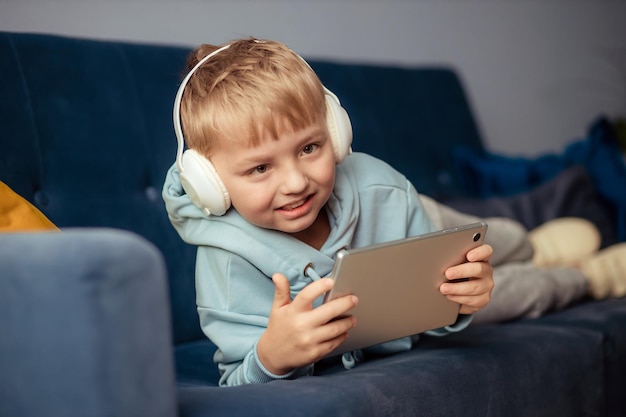 The boy at home communicates with friends on the Internet Education online learning homeschooling