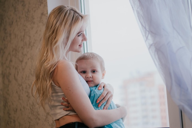 the boy hugs his mother. the child is with his mother.
