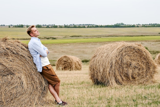 Boy Jumps From a Hay Stack in a Sunny Field