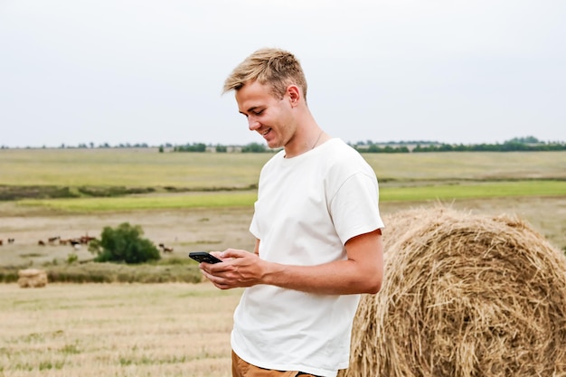 Boy Jumps From a Hay Stack in a Sunny Field