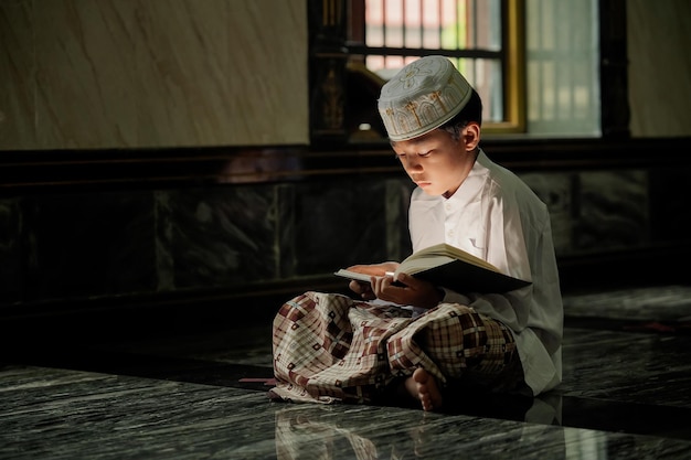 The boy learned to read the Quran from inside the mosque a concept of the next generation of Islamx9xA