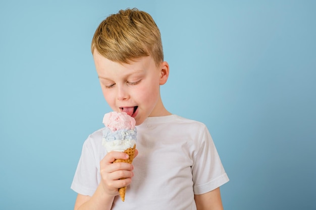 The boy licking ice cream closed his eyes dirty stain of ice cream on white clothes