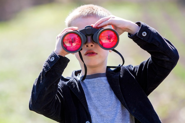 Boy looking through binoculars.