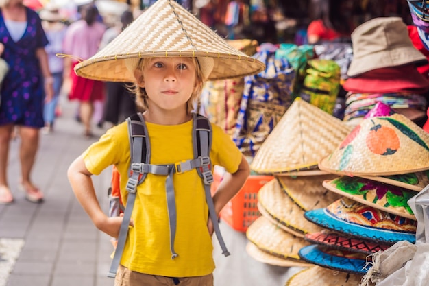 Boy at a market in Ubud Bali Typical souvenir shop selling souvenirs and handicrafts of Bali at the famous Ubud Market Indonesia Balinese market Souvenirs of wood and crafts of local residents