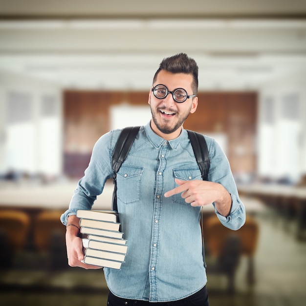 Boy nerd studying books for an exam