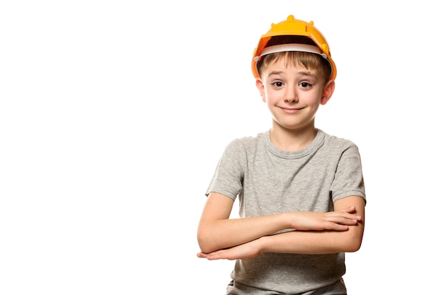 Boy in orange construction helmet with folded arms Portrait