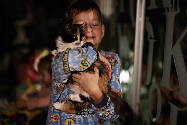 Boy playing with kitty at home during a blackout using alternative lighting