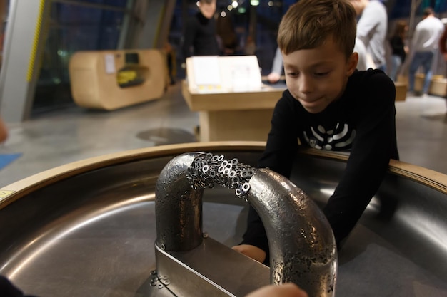 A boy plays in a large tub with a sign that says " the water is in the background "