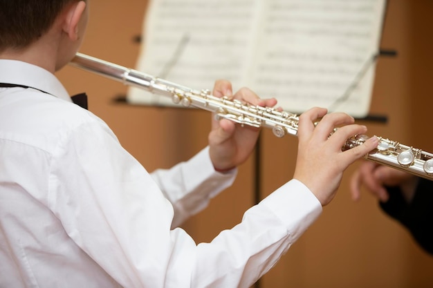 The boy plays the shining flute Wind musical instrument