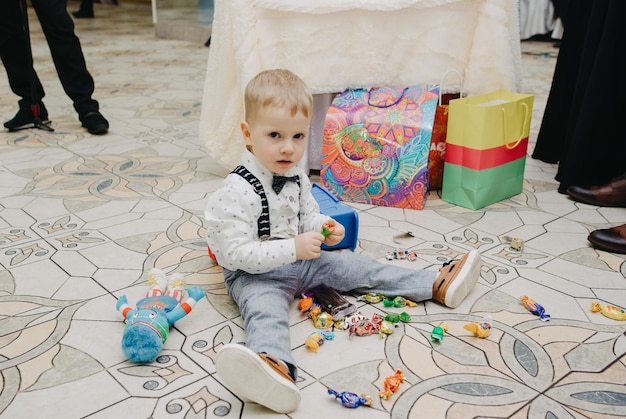 A boy plays with toys on the floor