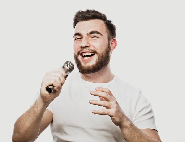 Photo boy rocking out image of a handsome bearded man singing to the microphone