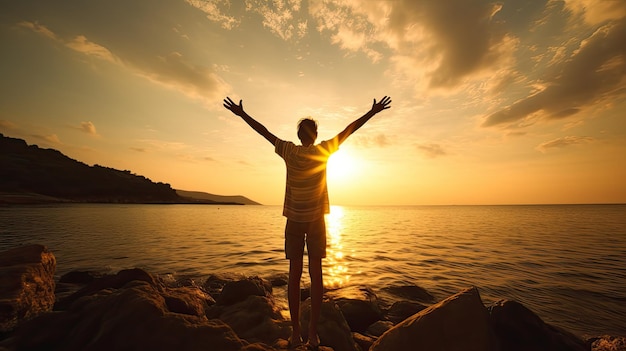 Boy s silhouette in sunset over sea representing religion worship prayer and praise