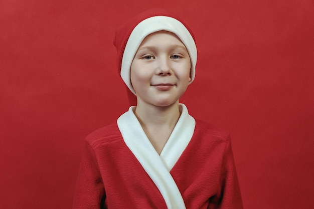 A boy in a santa claus costume